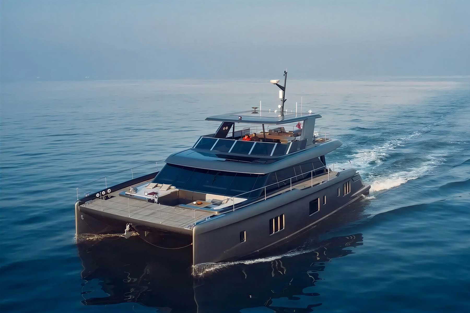 A modern, luxurious yacht cruises on calm, open water under a clear sky, leaving a gentle wake behind it.