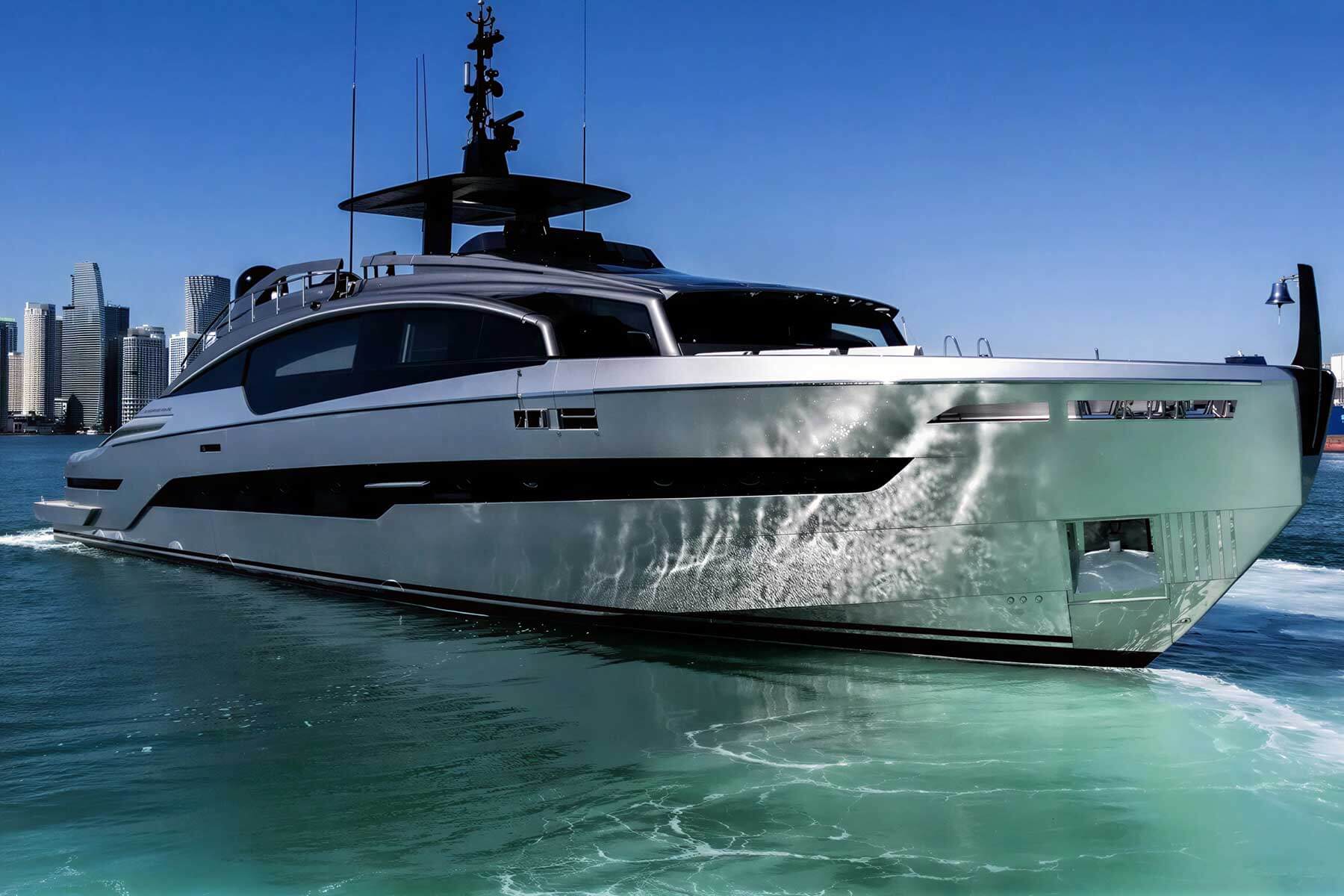 A modern luxury yacht cruises through clear blue water with a city skyline visible in the background under a sunny sky.